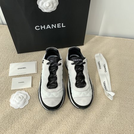 Chanel Letter Logo on the side of sneakers in black and white panda color