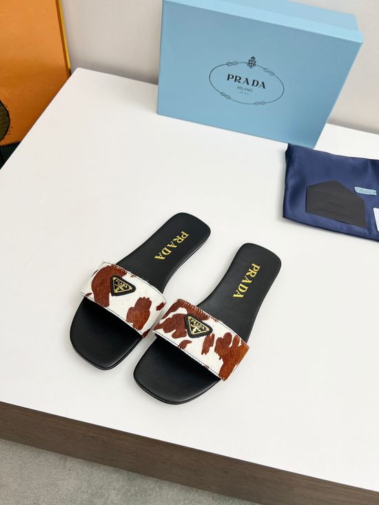Prada Cow Print Leather Loafers with Signature Emblem