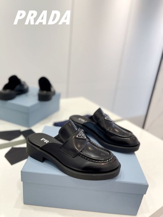 Prada Elegant Loafer Slippers with Trendy Triangular Logo