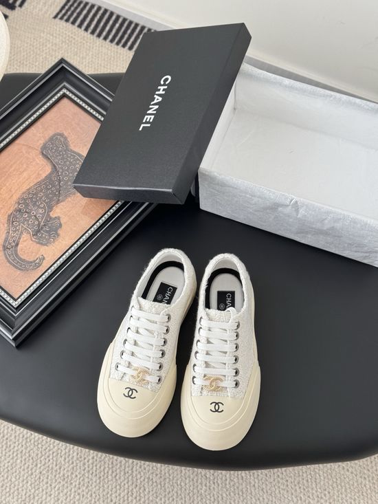 Chanel Stylish White Sneakers with Embossed Logo
