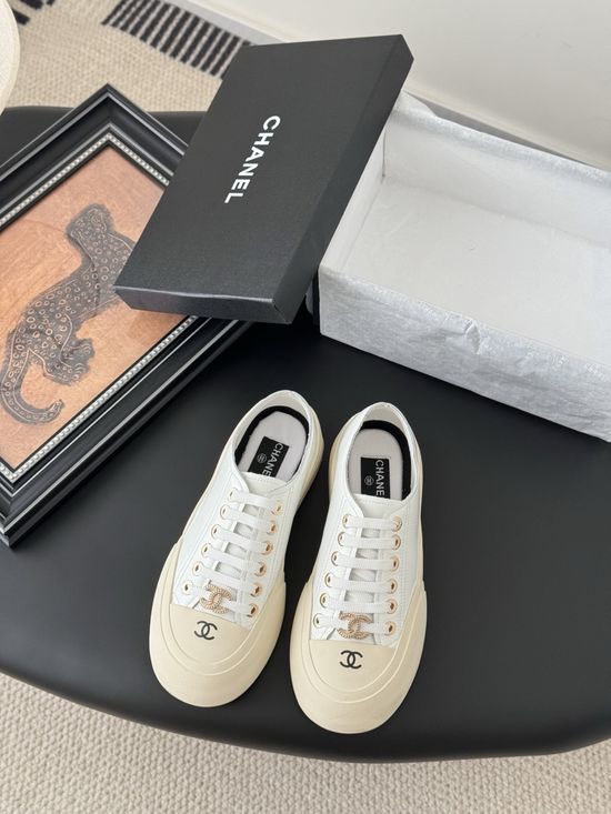 Chanel Stylish White Sneakers with Embossed Logo